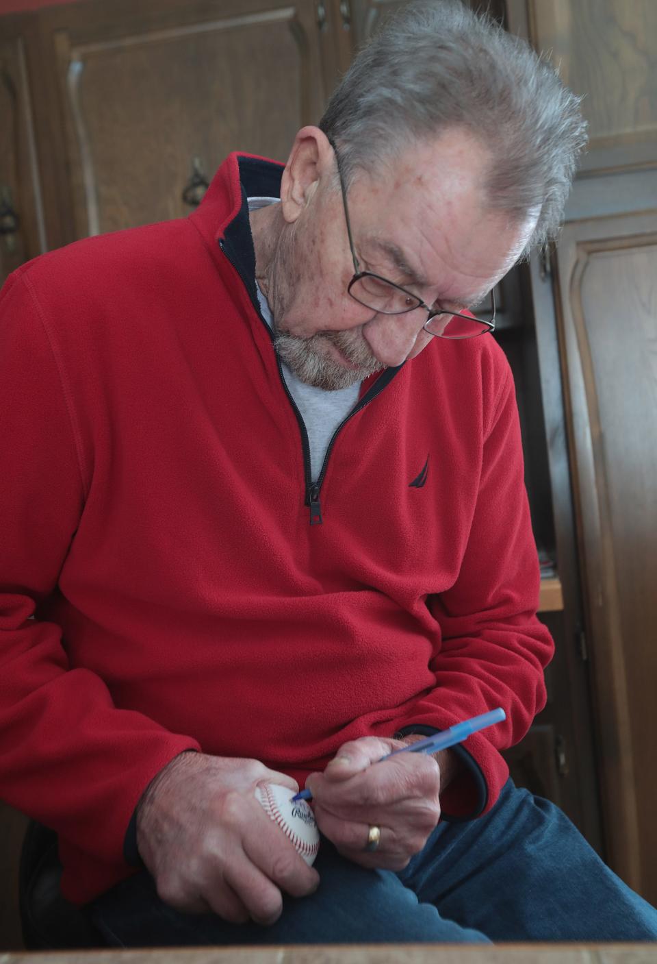 Jack DiLauro signs a ball for a fan at his Malvern home. The Akron native still gets several hundred requests per year in the mail. He played for the 1969 World Series champion New York Mets in one of his two Major League seasons.