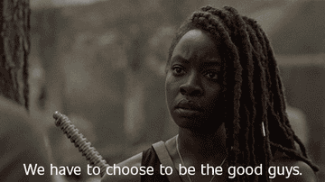 Michonee with a determined expression, holding a weapon, with the subtitle, "We have to choose to be the good guys" in a scene from The Walking Dead