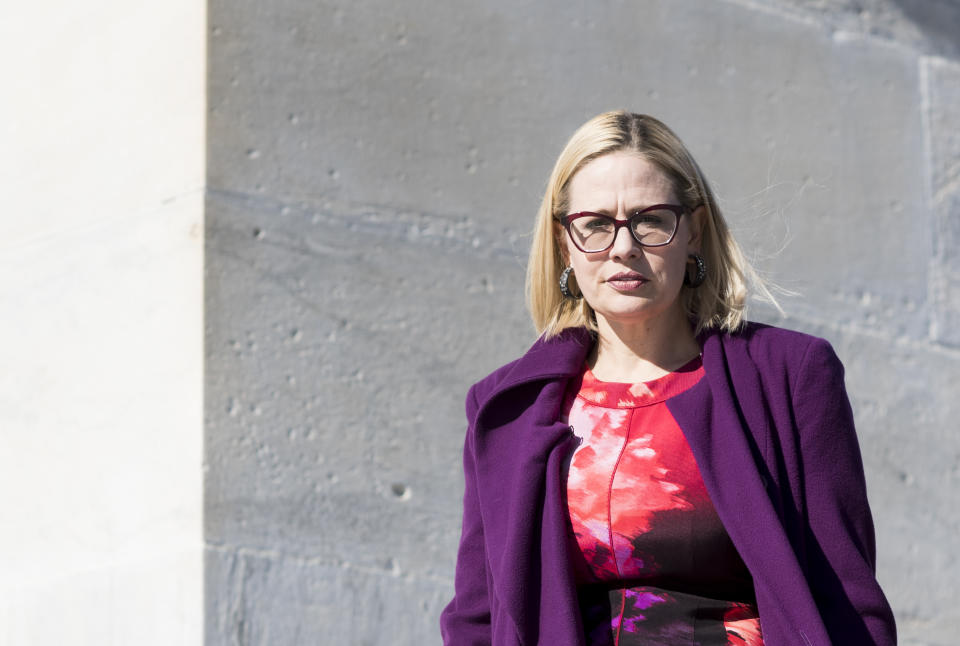 Rep. Kyrsten Sinema, D-Ariz., walks down the House steps following the final scheduled votes of the week on Friday, Jan. 19, 2018.