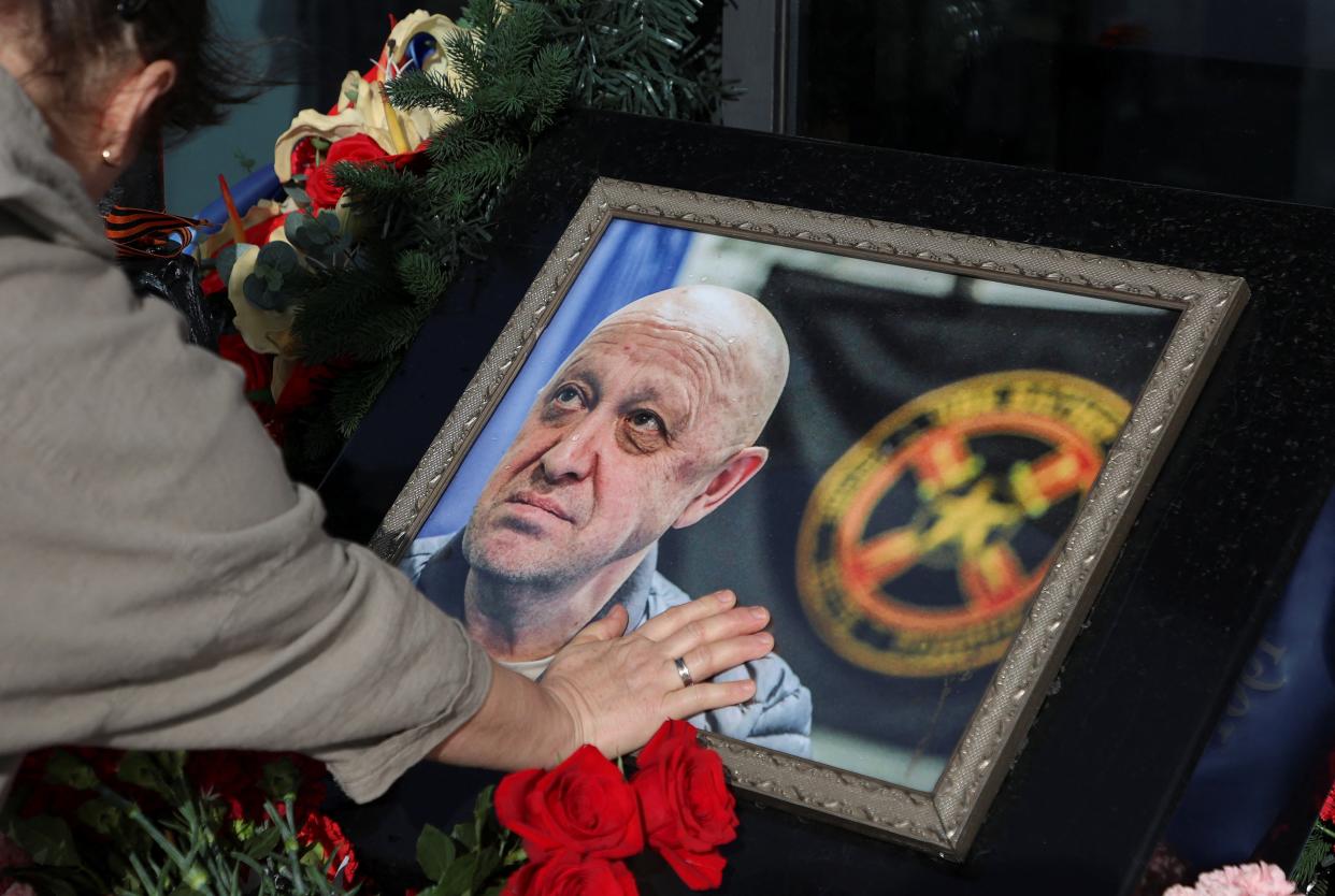 A woman mourns next to a makeshift memorial for Yevgeny Prigozhin (REUTERS)
