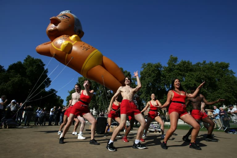 Dancers perform as a balloon depicting London Mayor Sadiq Khan in a yellow bikini floats above central London. Khan's critics launched the caricature after he let a giant "Baby Trump" balloon take to the capital's skies in July