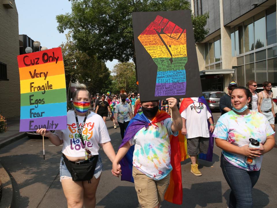 Marchers make their way through Eugene to join the 2021 Eugene Pride in the Park at Alton Baker Park.