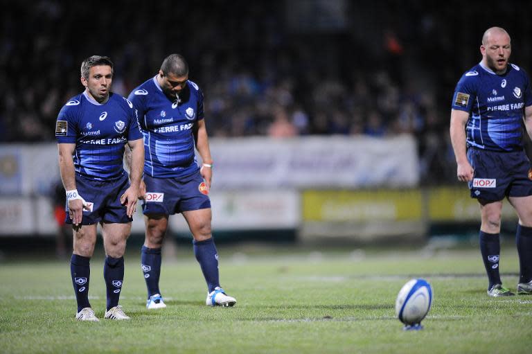 Castres fullback Romain Teulet (L) prepares to kick a penality during the French Top 14 rugby union match against Montpellier on April 18, 2014, at the Pierre Antoine stadium in Castres, southern France