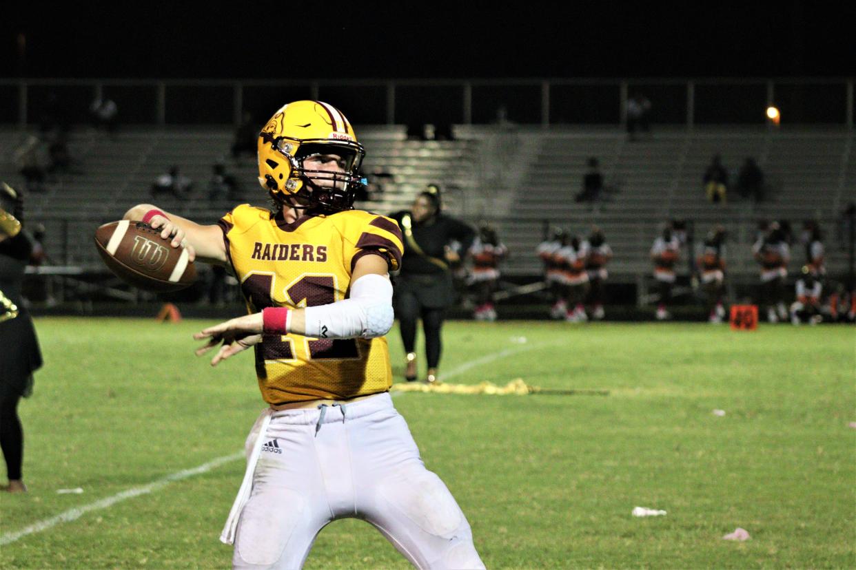 Glades Central quarterback Garrison Kepley warms up before the second half against Miami Carol City in Belle Glade, Florida on October 1, 2021.