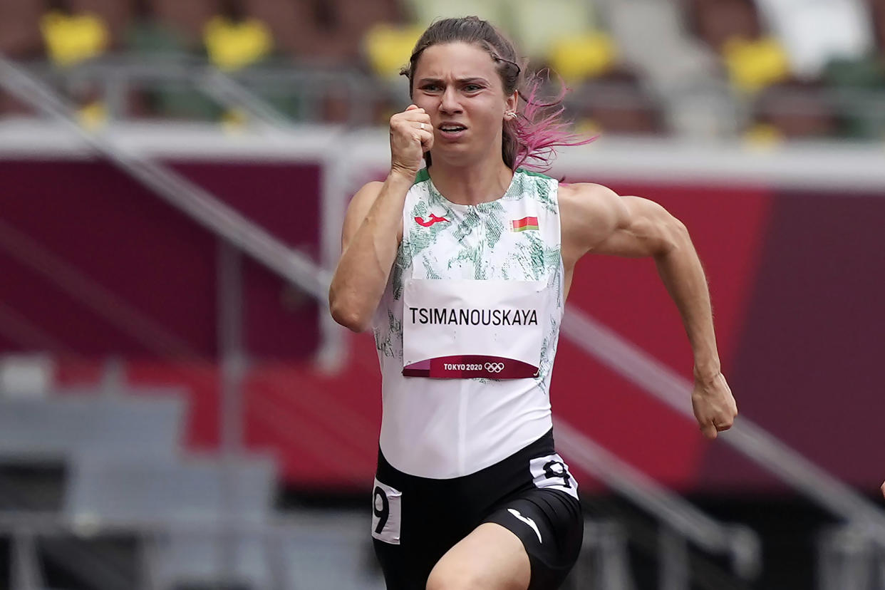 Image: Krystsina Tsimanouskaya, of Belarus, runs in the women's 100-meter run at the Tokyo Olympics on July 30, 2021. (Martin Meissner / AP)