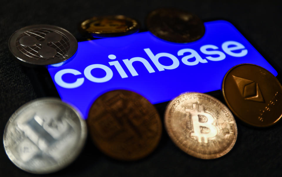 Coinbase logo displayed on a phone screen and representation of cryptocurrencies are seen in this illustration photo taken in Krakow, Poland on September 28, 2021. (Photo illustration by Jakub Porzycki/NurPhoto via Getty Images)