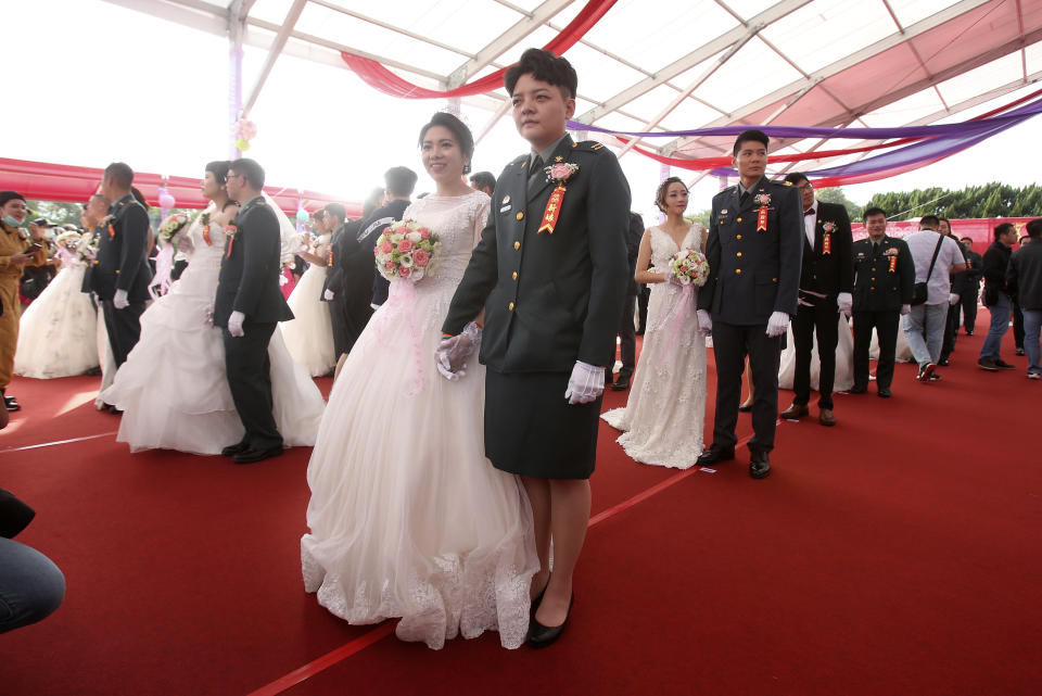 Lesbian couple Chen Ying-hsuan, right, and Li Li-chen attend a military mass weddings ceremony in Taoyuan city, northern Taiwan, Friday, Oct. 30, 2020. Two lesbian couples tied the knot in a mass ceremony held by Taiwan's military on Friday in a historic step for the island. Taiwan is the only place in Asia to have legalized gay marriage, passing legislation in this regard in May 2019. (AP Photo/Chiang Ying-ying)