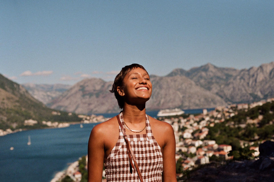 A smiling woman is soaking up the sun