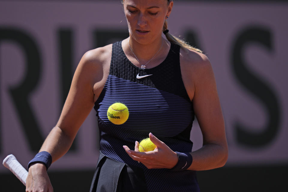 Czech Republic's Petra Kvitova watches tennis balls as she plays Belgium's Greet Minnen during their first round match of the French Open tennis tournament at the Roland Garros stadium Sunday, May 30, 2021 in Paris. (AP Photo/Thibault Camus)