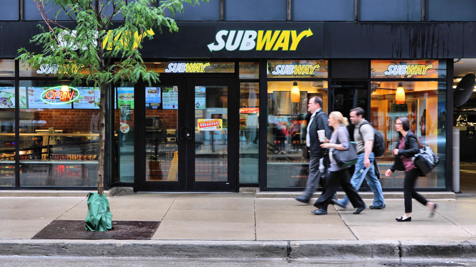 CHICAGO, USA - JUNE 26, 2013: People walk past Subway sandwich store in Chicago.