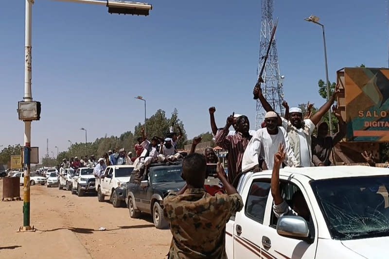 Sudanese supporters and army soldiers, loyal to army chief Abdel Fattah al-Burhan, celebrate after they seized a military base of their rival Rapid Support Forces (RSF) it in Shendi city, Sudan on April 18. Sudanese Armed Forces and the paramilitary Rapid Support Forces (RSF) are in a civil war that started April 15 that has worsened a humanitarian crisis. File Photo by Sudanese Armed Forces