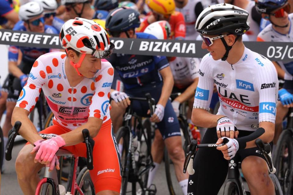 EF Education  Easyposts US rider Neilson Powless wearing the best climbers polka dot dotted jersey L speaks with UAE Team Emirates Slovenian rider Tadej Pogacar wearing the best young riders white jersey R as they await the start of the 3rd stage of the 110th edition of the Tour de France cycling race 1935 km between AmorebietaEtxano in Northern Spain and Bayonne in southwestern France on July 3 2023 Photo by Thomas SAMSON  AFP Photo by THOMAS SAMSONAFP via Getty Images