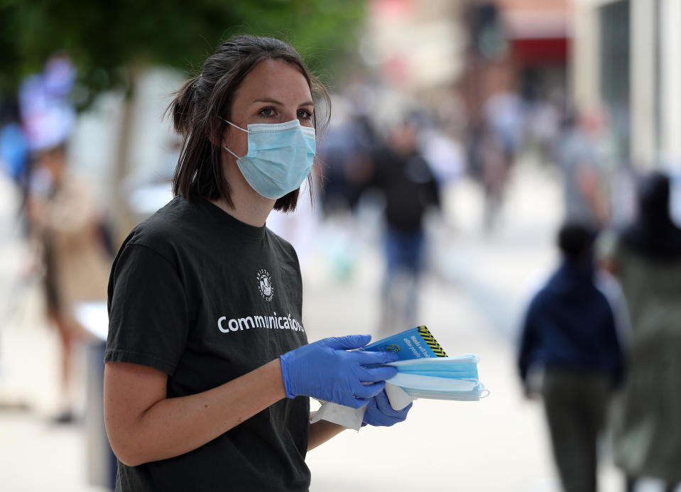 Bristol City Council staff hand out 80,000 face masks in Bristol city centre as face coverings become mandatory in shops and supermarkets in England. (Photo by Andrew Matthews/PA Images via Getty Images)