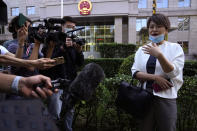 Teresa Xu speaks to journalists before a court session at the Chaoyang People's Court in Beijing, China, Friday, Sept. 17, 2021. After almost two years, the unmarried woman suing for the right to freeze her eggs in Beijing is getting her case heard in court Friday in a rare legal challenge against the country's restrictions on unmarried women in reproductive health. (AP Photo/Ng Han Guan)