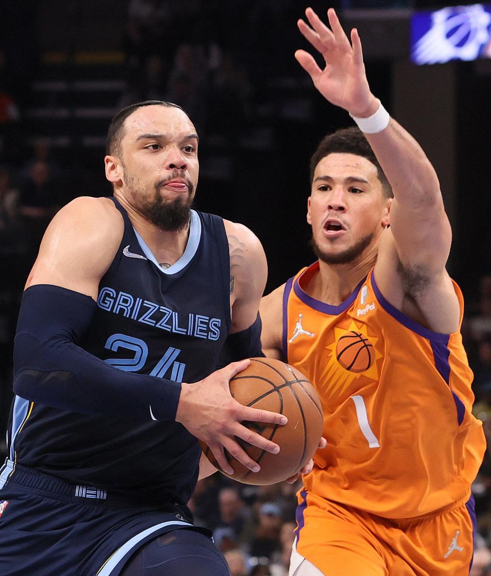 Apr 1, 2022; Memphis, Tennessee, USA; Memphis Grizzlies guard Dillon Brooks (24) drives past Phoenix Suns guard Devin Booker (1) at FedExForum. Mandatory Credit: Joe Rondone-USA TODAY Sports