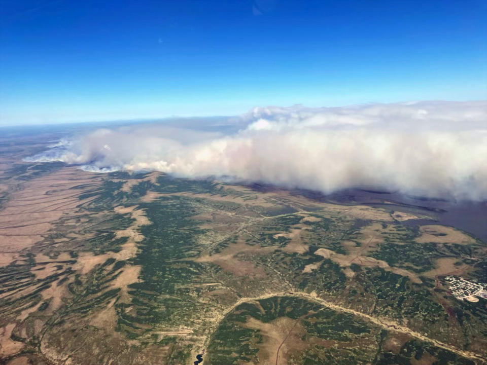 This Friday, June 10, 2022, aerial photo provided by the Bureau of Land Management Alaska Fire Service shows a tundra fire burning near the community of St. Mary's, Alaska. The largest documented wildfire burning through tundra in southwest Alaska was within miles St. Mary's and another nearby Alaska Native village, Pitkas Point, prompting officials Friday to urge residents to prepare for possible evacuation. (Ryan McPherson/Bureau of Land Management Alaska Fire Service via AP)