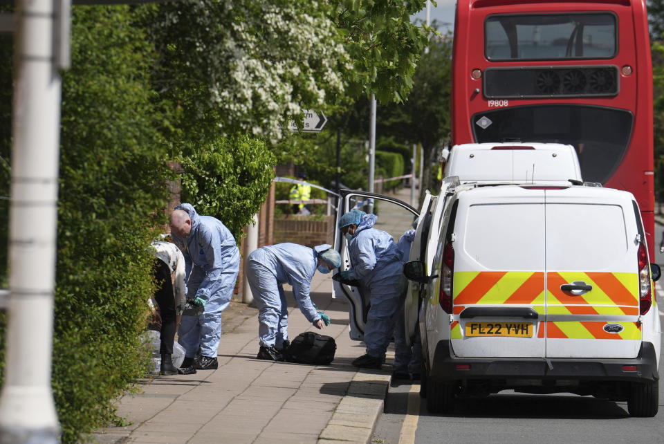 Forensic investigators in Hainault, north east London, Tuesday April 30, 2024. A man wielding a sword attacked members of the public and police officers in a east London suburb, killing a 13-year-old boy and injuring four others, authorities said Tuesday. A 36-year-old man was arrested at the scene, police said. Chief Supt. Stuart Bell said the incident is not being treated as terror-related or a “targeted attack.” (Jordan Pettitt/PA via AP)