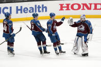 Colorado Avalanche goaltender Pavel Francouz, right, is congratulated by Kiefer Sherwood, left, Cale Makar, second from left, and Andre Burakovsky after the Avalanche defeated the Anaheim Ducks 2-0 in an NHL hockey game Wednesday, Jan. 19, 2022, in Anaheim, Calif. (AP Photo/Mark J. Terrill)
