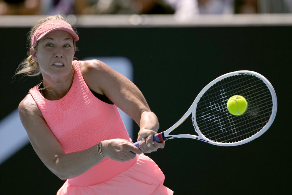 Danielle Collins of the U.S. plays a backhand return to Angelique Kerber of Germany during their first round match at the Australian Open tennis championships at Melbourne Park, Melbourne, Australia, Tuesday, Jan. 16, 2024. (AP Photo/Alessandra Tarantino)