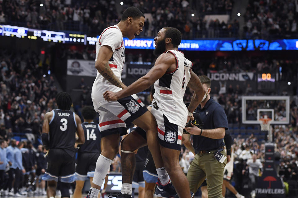 Connecticut's Jordan Hawkins, left, and R.J. Cole celebrate at the end of the team's NCAA college basketball game against Villanova, Tuesday, Feb. 22, 2022, in Hartford, Conn. (AP Photo/Jessica Hill)