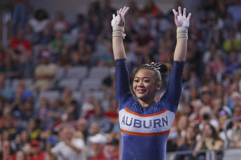 Auburn's Sunisa Lee celebrates after competing in the vault during the NCAA college women's gymnastics championships, Saturday, April 16, 2022, in Fort Worth, Texas. (AP Photo/Gareth Patterson)