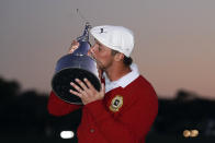 Bryson DeChambeau kisses the championship trophy after he won the Arnold Palmer Invitational golf tournament Sunday, March 7, 2021, in Orlando, Fla. (AP Photo/John Raoux)