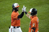 Baltimore Orioles' Rio Ruiz, left, is greeted near the dugout by Pat Valaika after hitting a two-run home run off Tampa Bay Rays starting pitcher Trevor Richards during the fourth inning of the second game of a baseball doubleheader, Thursday, Sept. 17, 2020, in Baltimore. (AP Photo/Julio Cortez)