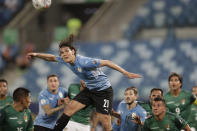 Uruguay's Edinson Cavani, center, heads the ball during a Copa America soccer match against Bolivia at Arena Pantanal in Cuiaba, Brazil, Thursday, June 24, 2021. (AP Photo/Andre Penner)