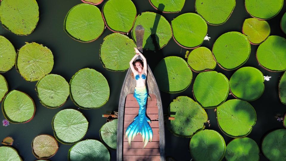 Marielle Henault poses among lilypads in Thailand. / Credit: Marielle Henault