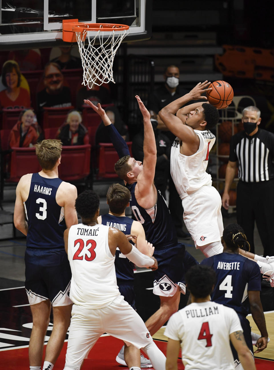 San Diego State forward Matt Mitchell (11) shoots over BYU forward Kolby Lee (40) during the second half of an NCAA college basketball game Friday, Dec. 18, 2020, in San Diego. (AP Photo/Denis Poroy)