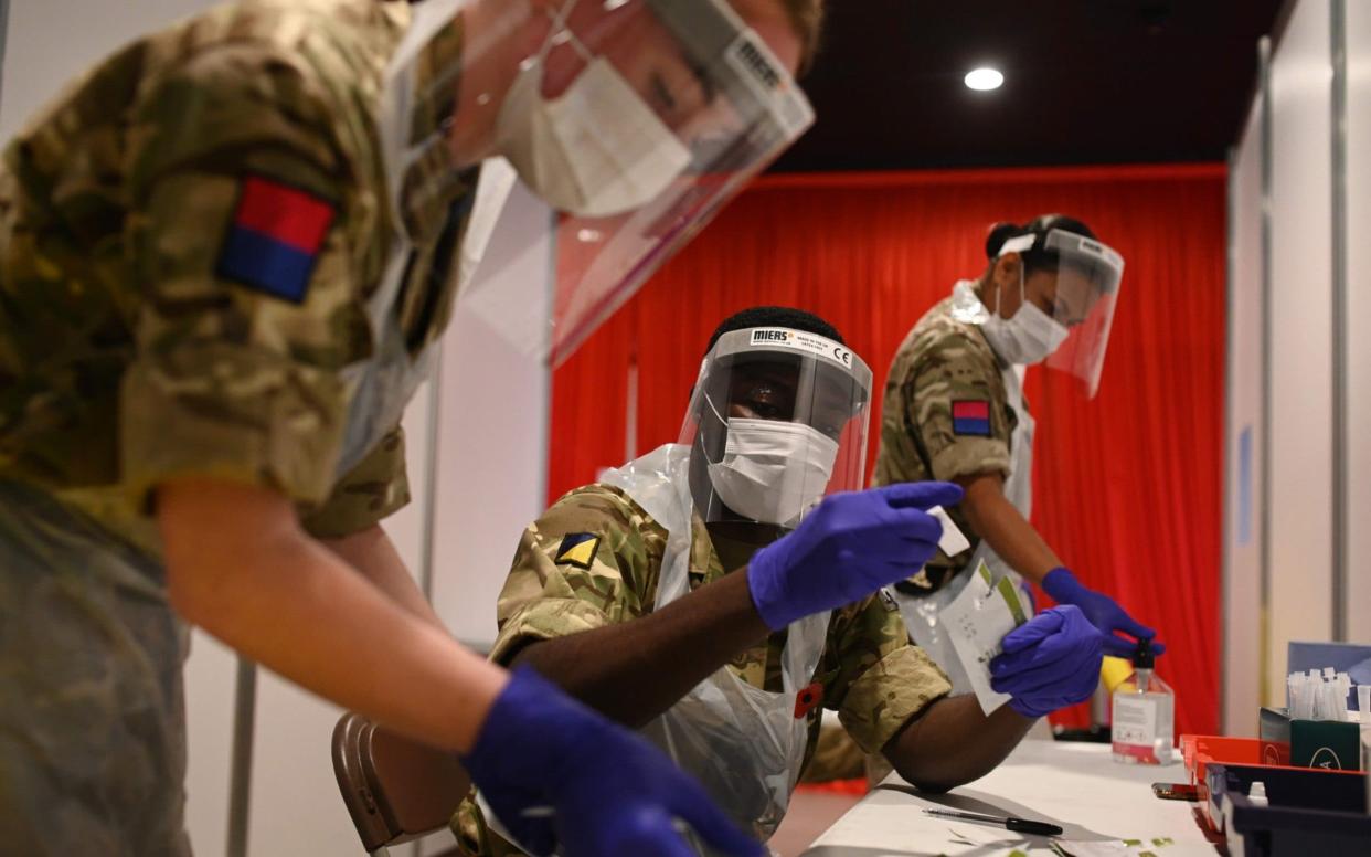 British Army soldiers, 19th Regiment Royal Artillery 5 Battery, process and record coronavirus tests inside Anfield Stadium in Liverpool - OLI SCARFF/AFP