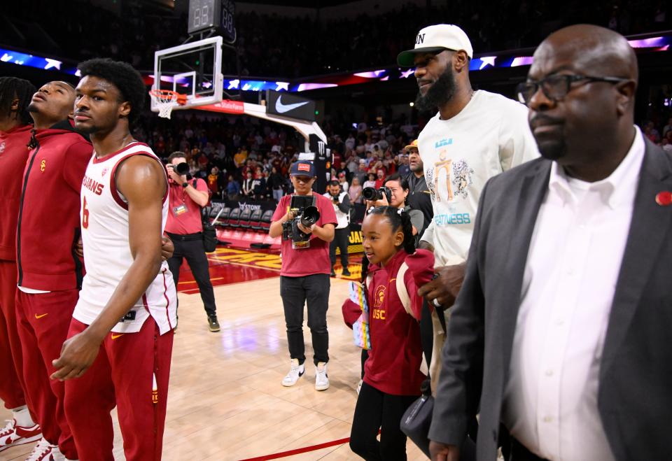 LeBron James mingles courtside before his son Bronny and his USC teammates get ready to face Long Beach State in a game last December.