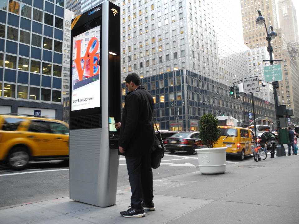 A man uses a LinkNYC station in New York, USA, 23 March 2016. These stations offer free Wi-Fi in the city.  / Credit: Johannes Schmitt-Tegge/AP Images