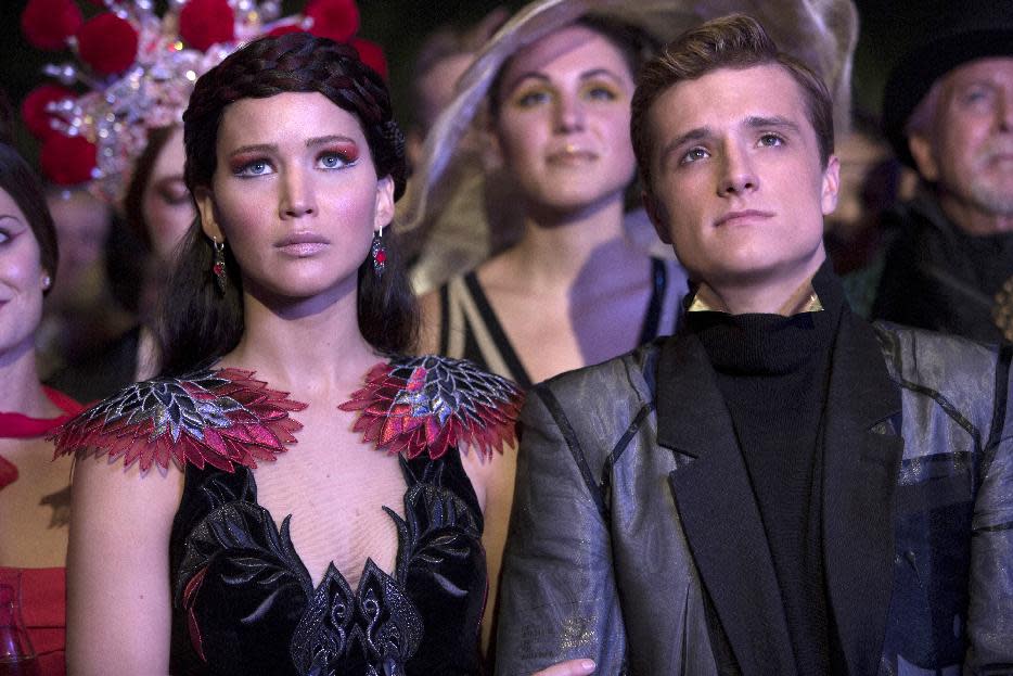 This image released by Lionsgate shows Jennifer Lawrence as Katniss Everdeen, left, and Josh Hutcherson as Peeta Mellark in a scene from "The Hunger Games: Catching Fire." The film releases Nov. 22, 2013. (AP Photo/Lionsgate, Murray Close)