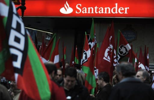 Anti-austerity demonstrators near a branch of Spanish bank Santander in Bilbao in February. Santander shares, along with shares in other Spanish banks, tumbled Friday as the government readied drastic reforms to save their balance sheets, two days after nationalising the fourth-biggest bank, Bankia