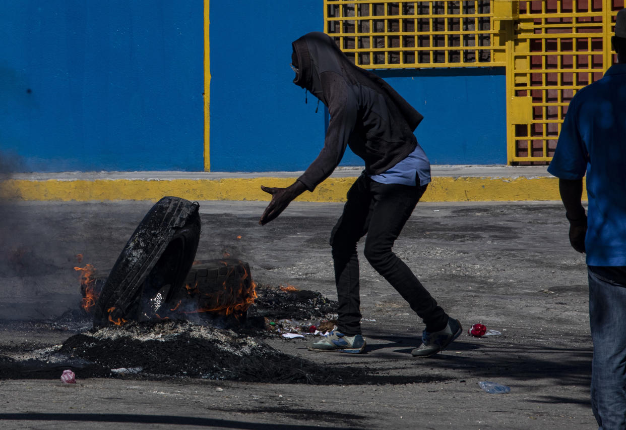 Jimmy Cherizier, líder de la pandilla G9, sostenía un retrato de Moïse durante la manifestación de julio. Cherizier se presenta como un líder político, convoca conferencias de prensa y lidera marchas. (Victor Moriyama/The New York Times)