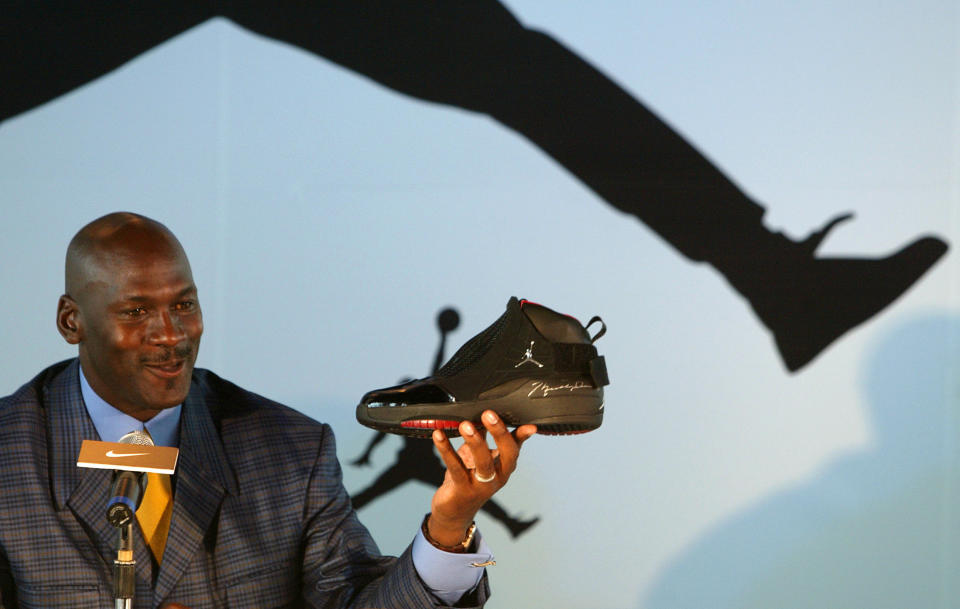 U.S. basketball legend Michael Jordan displays a shoe during a news conference in Hong Kong May 21, 2004. (Photo: REUTERS/Bobby Yip BY/TW)