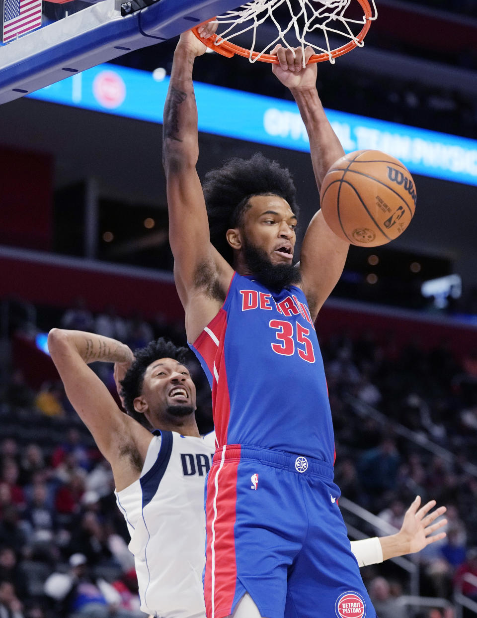Detroit Pistons forward Marvin Bagley III (35) dunks as Dallas Mavericks center Christian Wood defends during the first half of an NBA basketball game, Thursday, Dec. 1, 2022, in Detroit. (AP Photo/Carlos Osorio)