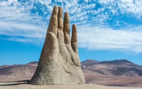 Hand sculpture in the Atacama Desert by Chilean sculptor Mario Irarrazabal - Credit: iStock