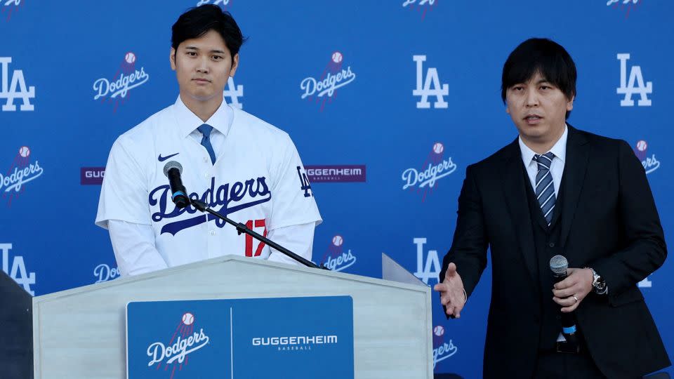 Shohei Ohtani, left, and his then-interpreter Ippei Mizuhara speak on December 14, 2023. - Aude Guerrucci/Reuters