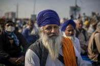 Indian farmers gather in protest against new farm laws at the Delhi-Uttar Pradesh state border, India, Wednesday, Jan. 20, 2021. Farmers have been blockading highways connecting New Delhi to northern India for nearly seven weeks against new farm laws, obstructing transportation and dealing a blow to manufacturing and businesses in the north. Farmers fear the government will stop buying grain at minimum guaranteed prices and that corporations will then push prices down under the new laws. (AP Photo/Altaf Qadri)