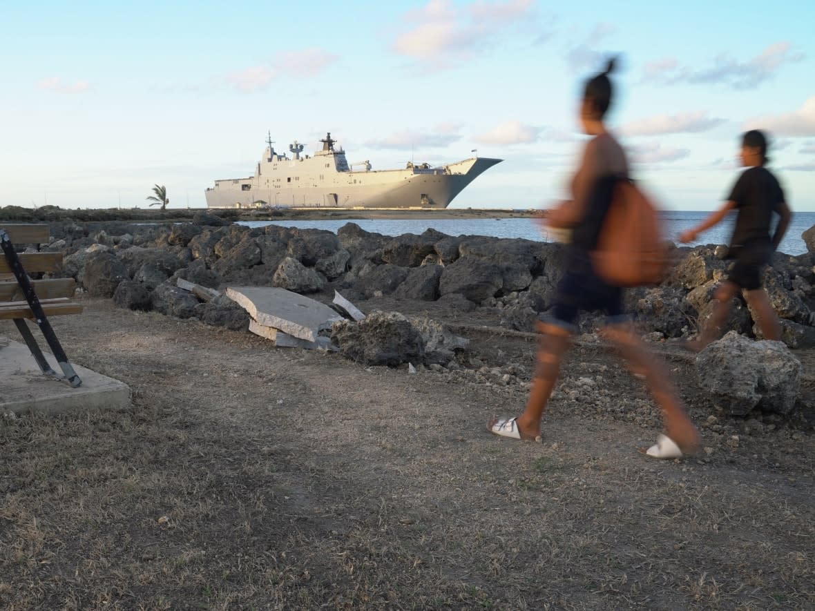 The Australian Navy's HMAS Adelaide docked at Vuna Wharf in Tonga's capital Nukualofa to deliver aid following the Jan. 15 eruption of the nearby Hunga Tonga-Hunga Ha'apai underwater volcano.  (Mary Lyn Fonua/Matangi Tonga/AFP/Getty Images - image credit)