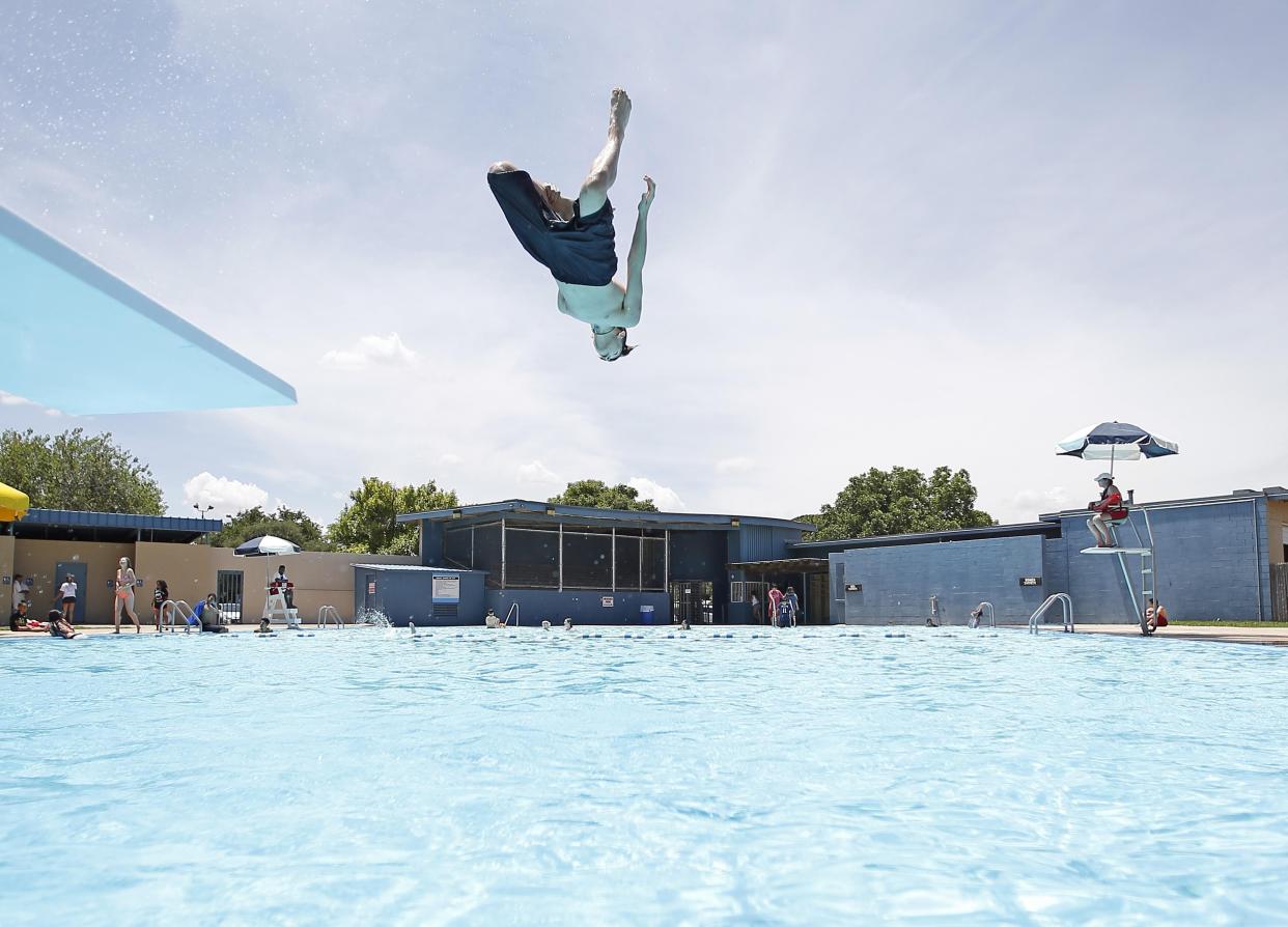 Mason Malone dives into Lubbock's Maxey Pool on May 30, 2017.