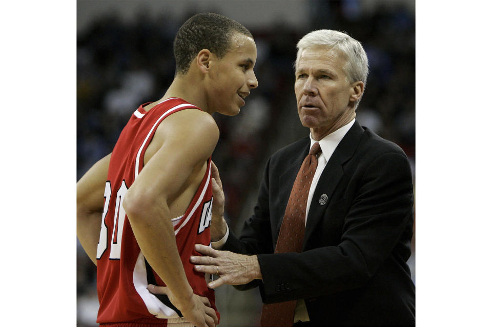 FILE - Davidson's head coach Bob McKillop, right, speaks with Stephen Curry during the first half of a first round NCAA Midwest Regional basketball game against Gonzaga in Raleigh, N.C., Friday, March 21, 2008. Longtime Davidson coach Bob McKillop is retiring, ending a run that included coaching NBA star Stephen Curry with the Wildcats and ranking among the Division I mens basketballs winningest active coaches. McKillop announced his retirement Friday, June 17, 2022, at a campus news conference, effective at the end of the month. (AP Photo/Chuck Burton, File)