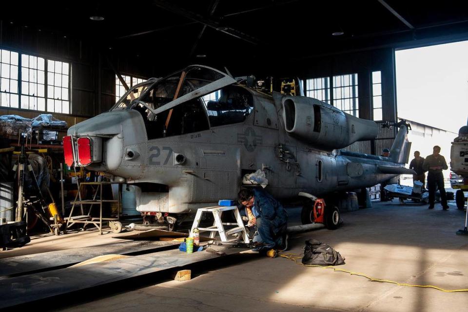 Restoration work takes place on a Bell AH-1W Cobra attack helicopter inside Castle Air Museum’s restoration hanger in Atwater, Calif., on Wednesday, Jan. 12, 2022. According to Castle Air Museum Chief Executive Director Joe Pruzzo, both the Bell AH-1W Cobra attack helicopter and a SH-60B Seahawk helicopter were acquired from Hawaii in 2021. When ready, the aircraft will be displayed on the Castle Air Museum grounds along with dozens of other vintage aircraft.