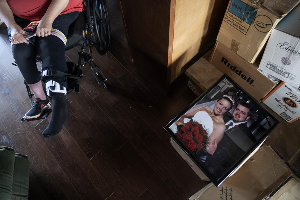 A wedding portrait of Missy Jenkins Smith and her husband, Josh, sits atop a box as the couple prepares to move out of their home in Kirksey, Ky., Monday, June 5, 2023. (AP Photo/David Goldman)