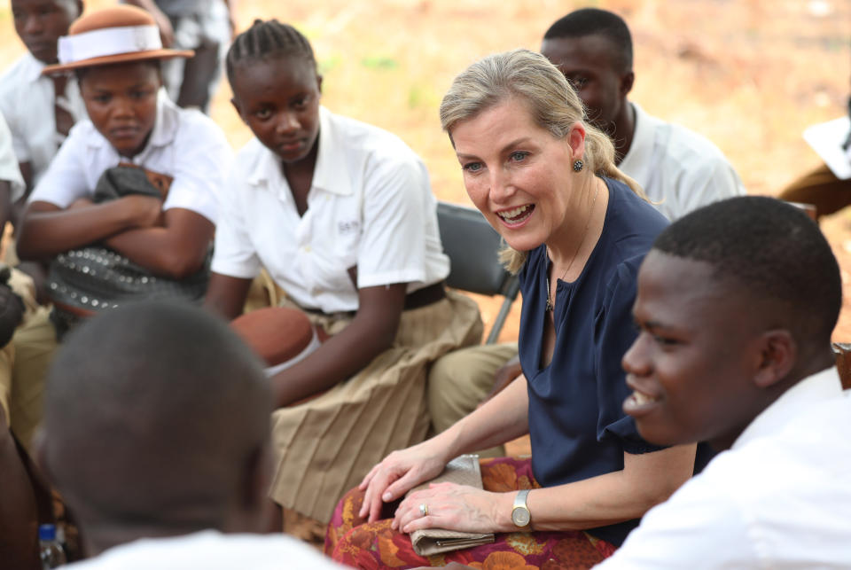 The Countess of Wessex joins students underneath a tree in the school yard to observe a a life skills lesson which introduces students to the topic of sexual and gender based violence at the Russell Technical Secondary School, Russell, Sierra Leone, on the second day of her visit to Sierra Leone. (Photo by Jonathan Brady/PA Images via Getty Images)