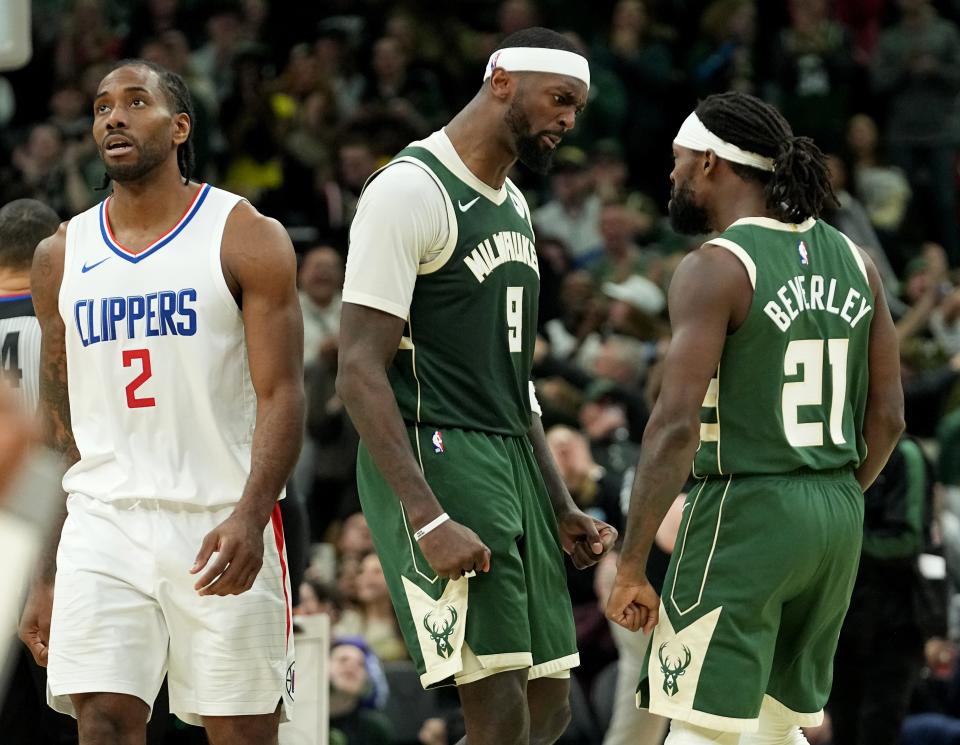 Bucks forward Bobby Portis celebrates a three-point basket with guard Patrick Beverley late in their game Monday as Clippers forward Kawhi Leonard looks on.