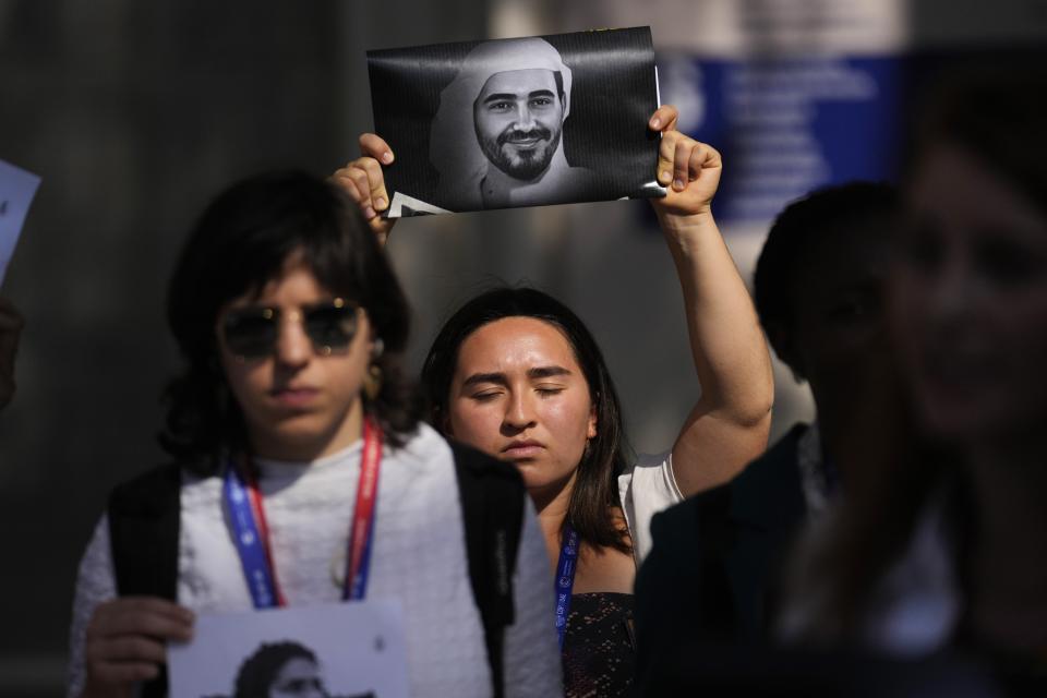 Activists participate in a demonstration with the image of jailed activist Mohamed al-Siddiq at the COP28 U.N. Climate Summit, Saturday, Dec. 9, 2023, in Dubai, United Arab Emirates. (AP Photo/Rafiq Maqbool)