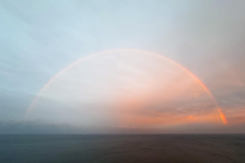 A rainbow forms over the Pacific Ocean near Black's Beach, Thursday, Feb. 1, 2024, in San Diego. The first of two back-to-back atmospheric rivers drenched California on Thursday, flooding roads and toppling trees while triggering statewide storm preparations and calls for people to get ready for powerful downpours, heavy snow and damaging winds. (AP Photo/Denis Poroy)